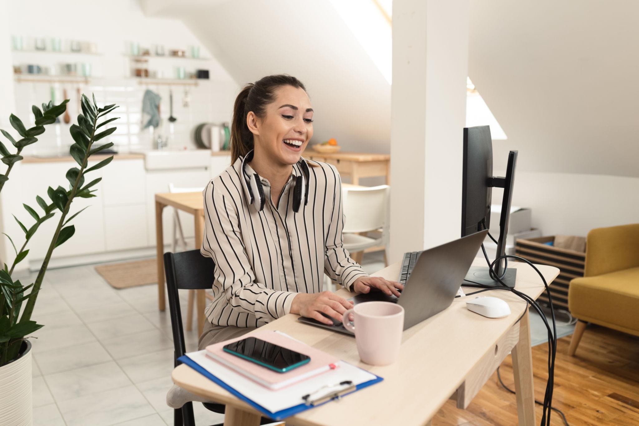 Freelance professional working from a home office during a video call, representing a successful transition from a full-time job to freelancing.